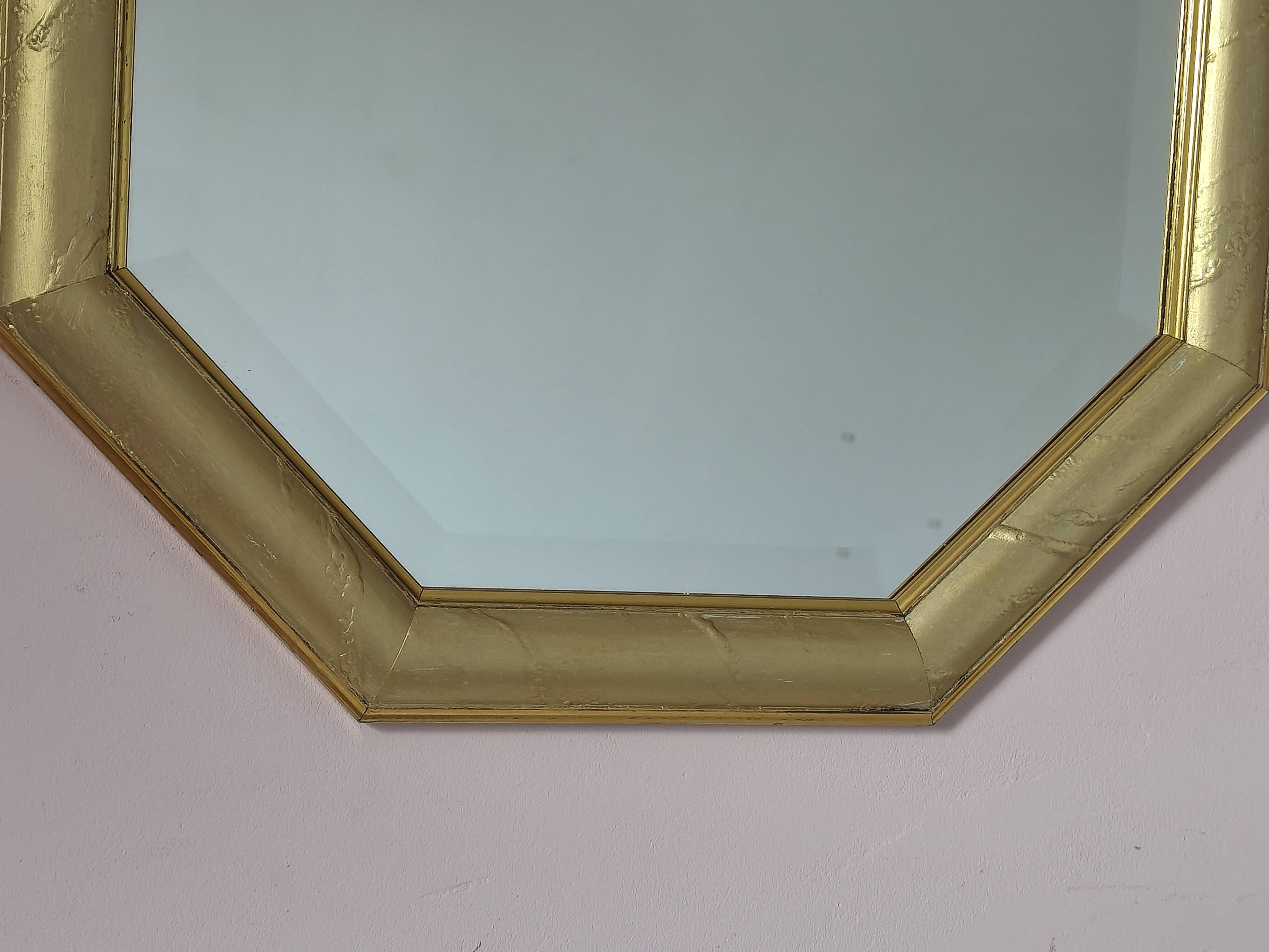 Golden octagonal mirror with bevelled glass from the 1970s.