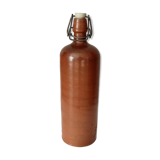 Old bottle in glazed sandstone