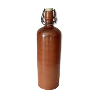 Old bottle in glazed sandstone
