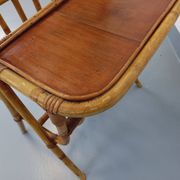 Side table with vintage rattan and wood magazine rack from the 60s