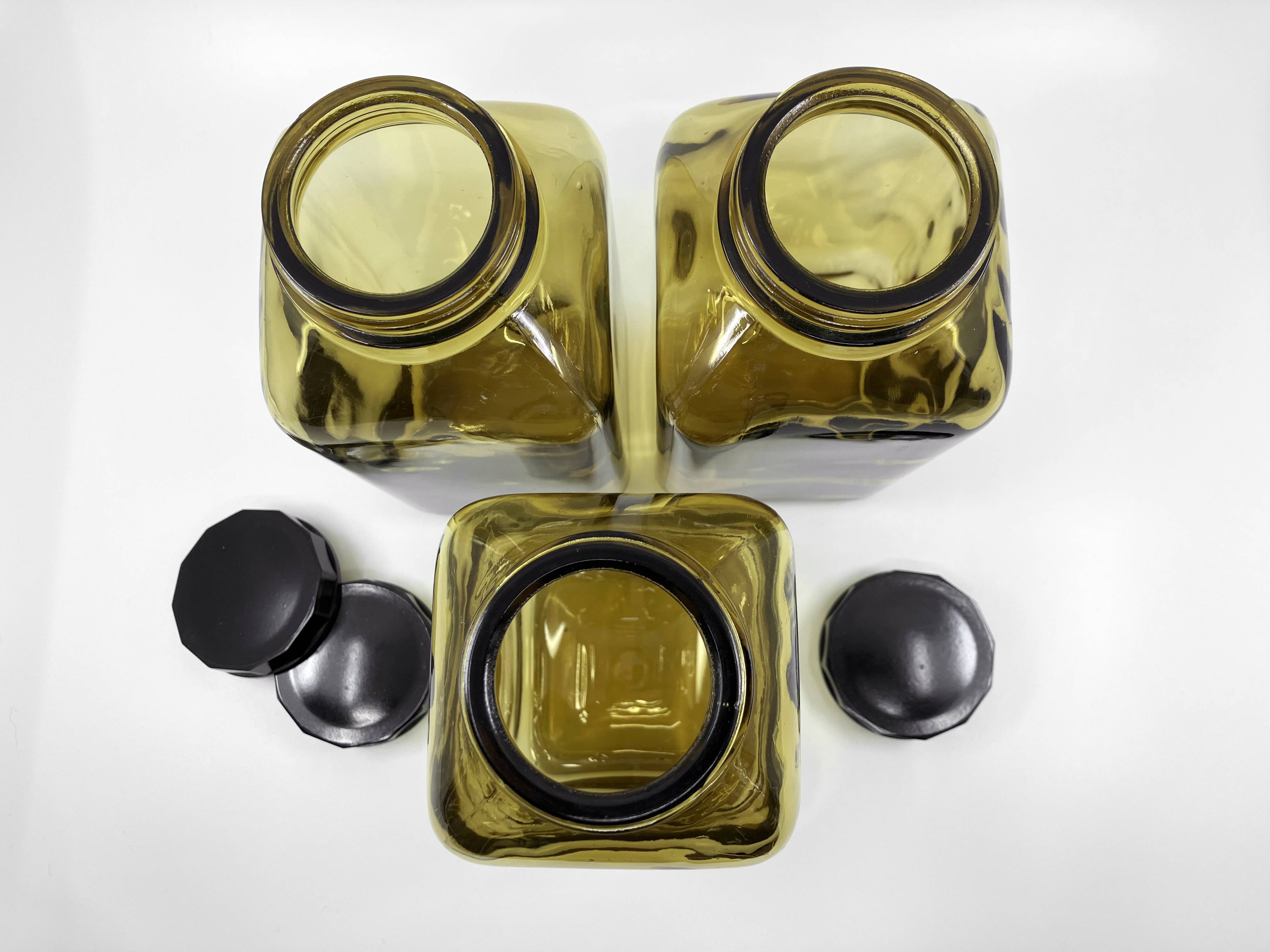 3 molded amber glass pharmacy bottles • Bakelite stoppers • 1950