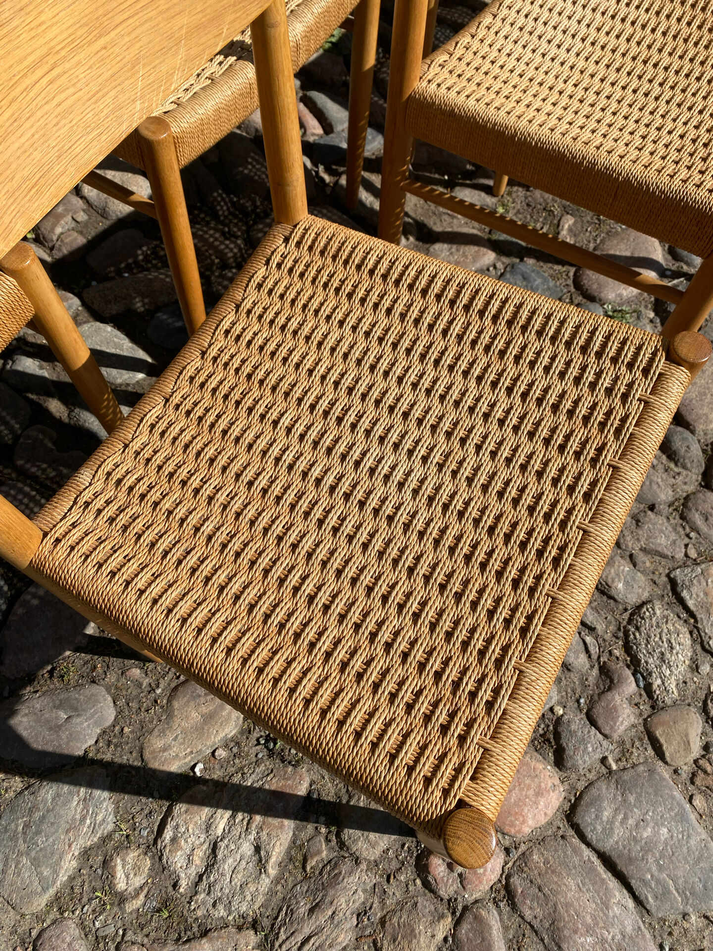 8 dining chairs in oak  w/ paper cord
