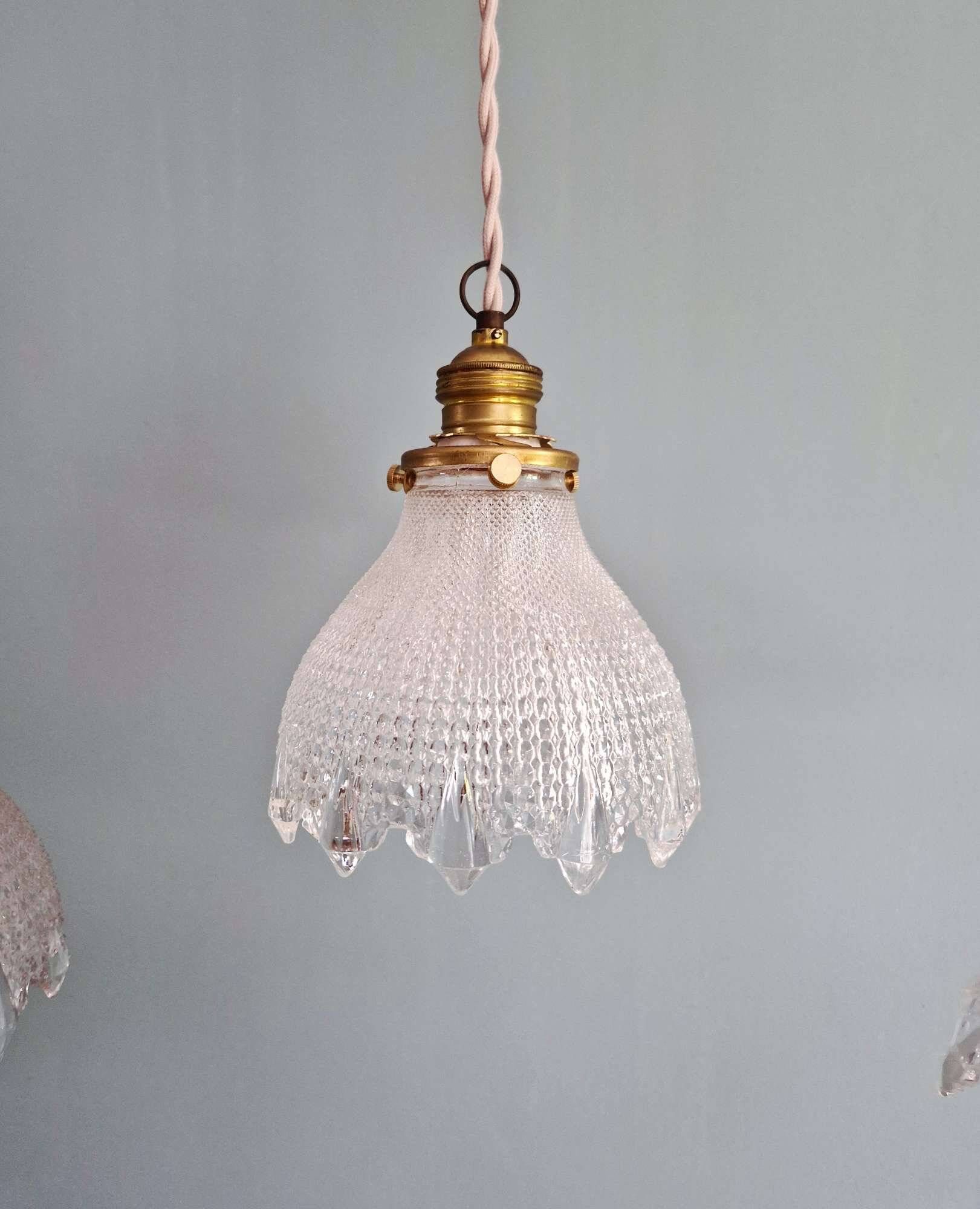 Trio of Art Deco scalloped clear glass pendant lights, 1920-30