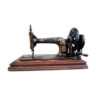 Singer sewing machine with an old 19th century crank