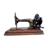 Singer sewing machine with an old 19th century crank