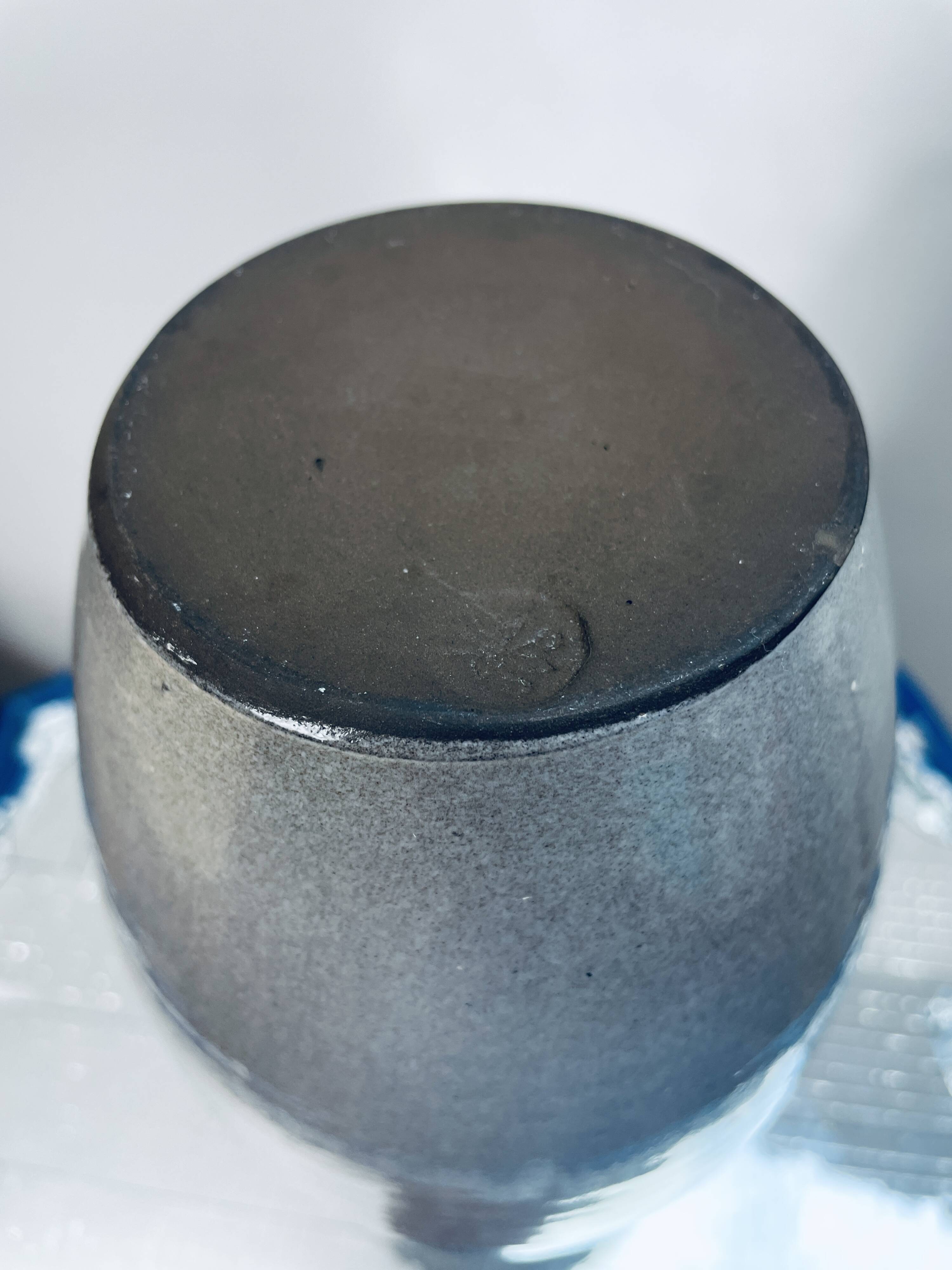 Handcrafted gray stoneware vase with child illustration