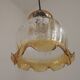French vintage amber and clear glass ceiling light with white floral decoration.