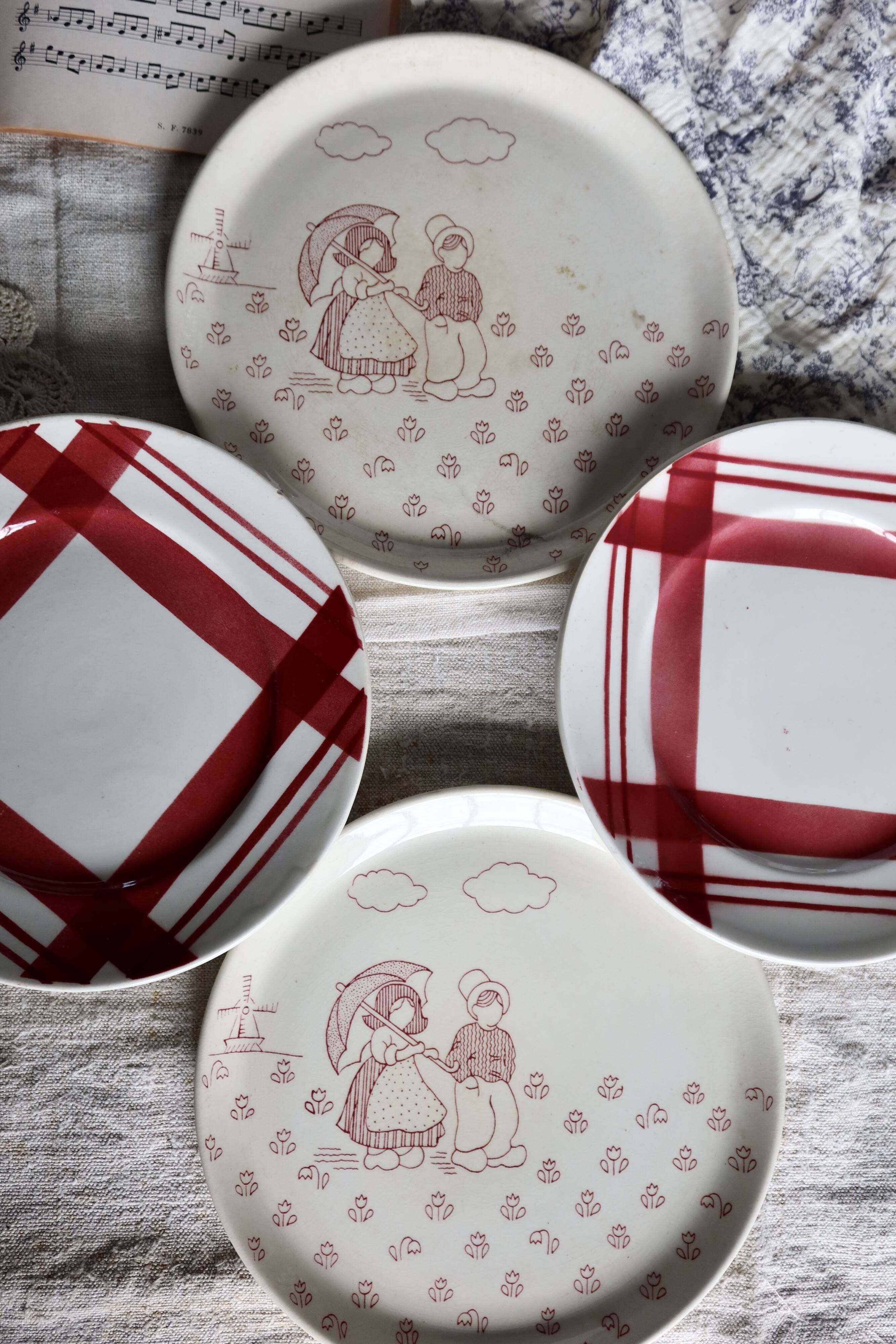 Vintage mismatched earthenware dessert plates with red patterns