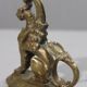 Handheld candlestick in bronze featuring a griffin, 19th-century Empire style.