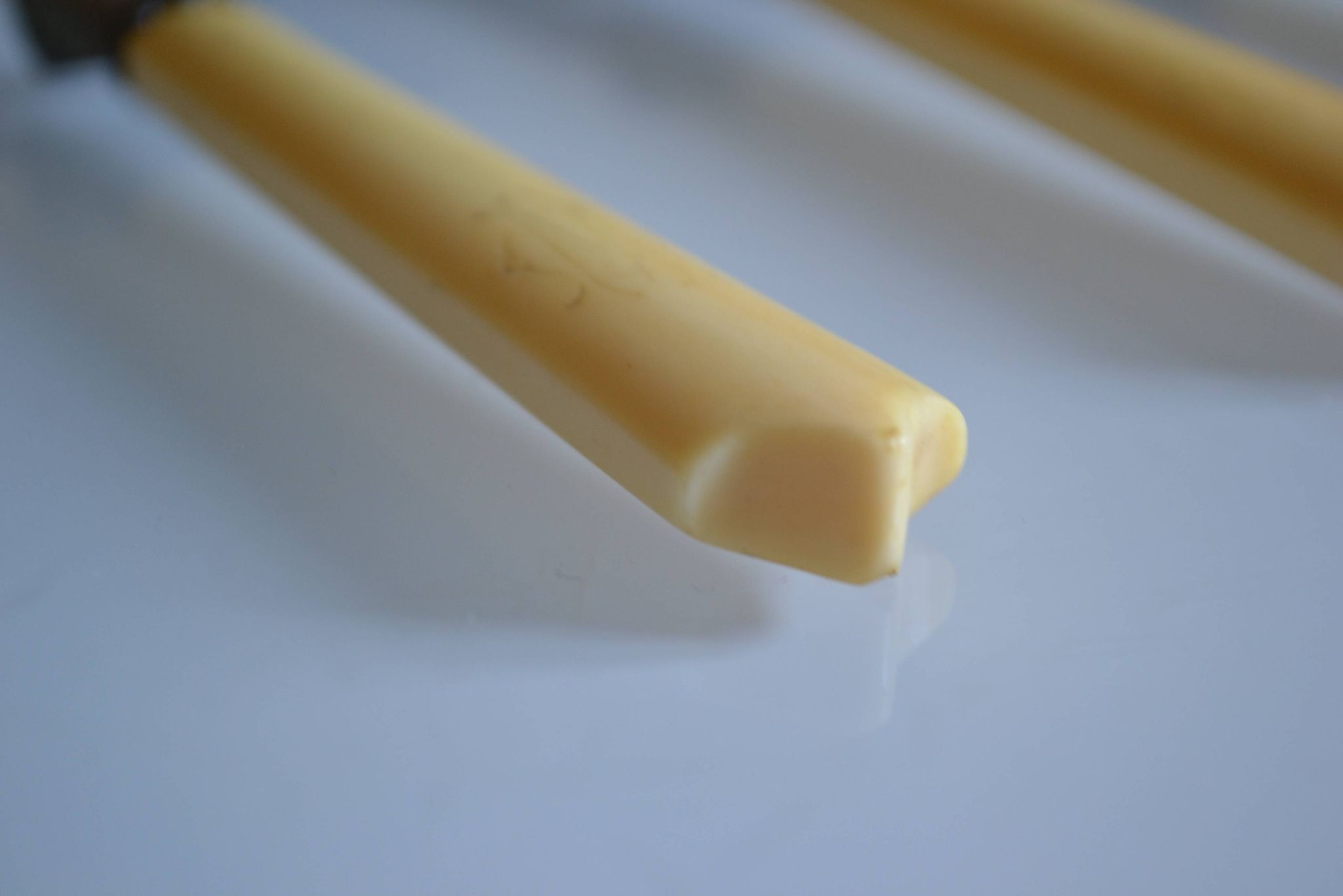 11 antique 19th-century table knives with ivory-colored monogram handles