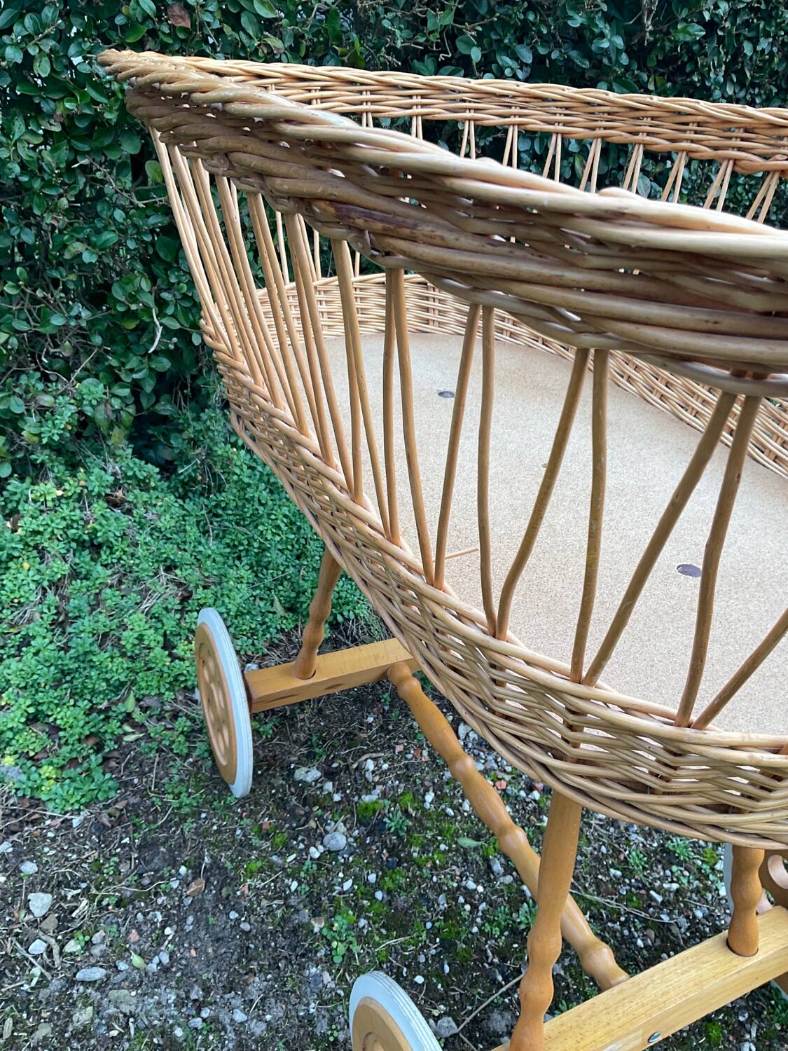 Vintage wicker cradle on casters