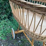 Vintage wicker cradle on casters