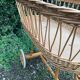 Vintage wicker cradle on casters