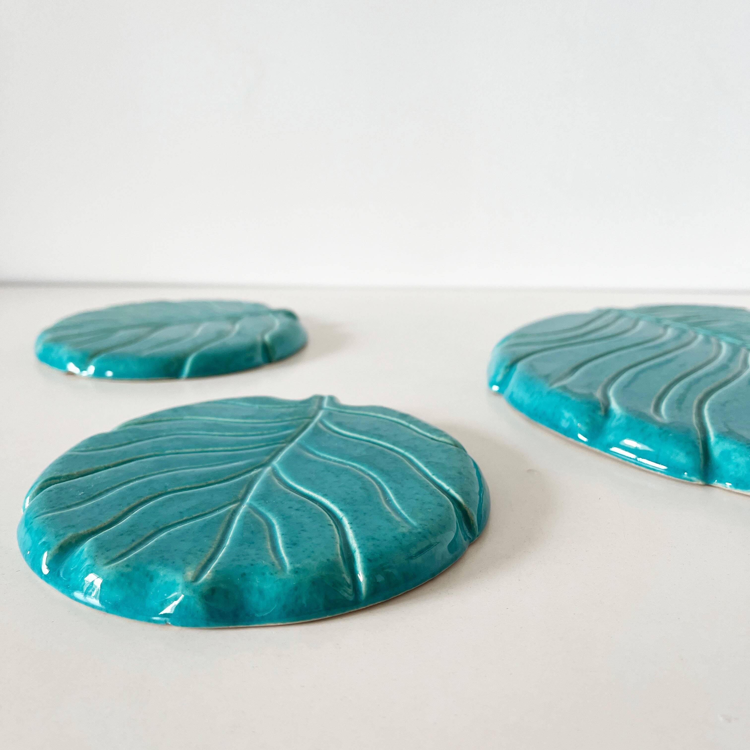 Ceramic trivet and bottle coaster from the 1950s.