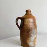 Old rustic stoneware bottle with handle