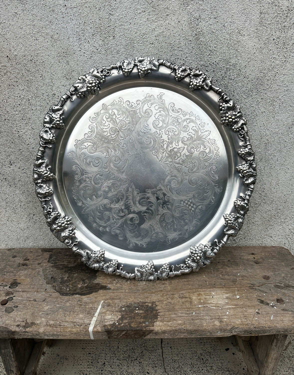 Antique round silver serving platter, grape motifs.