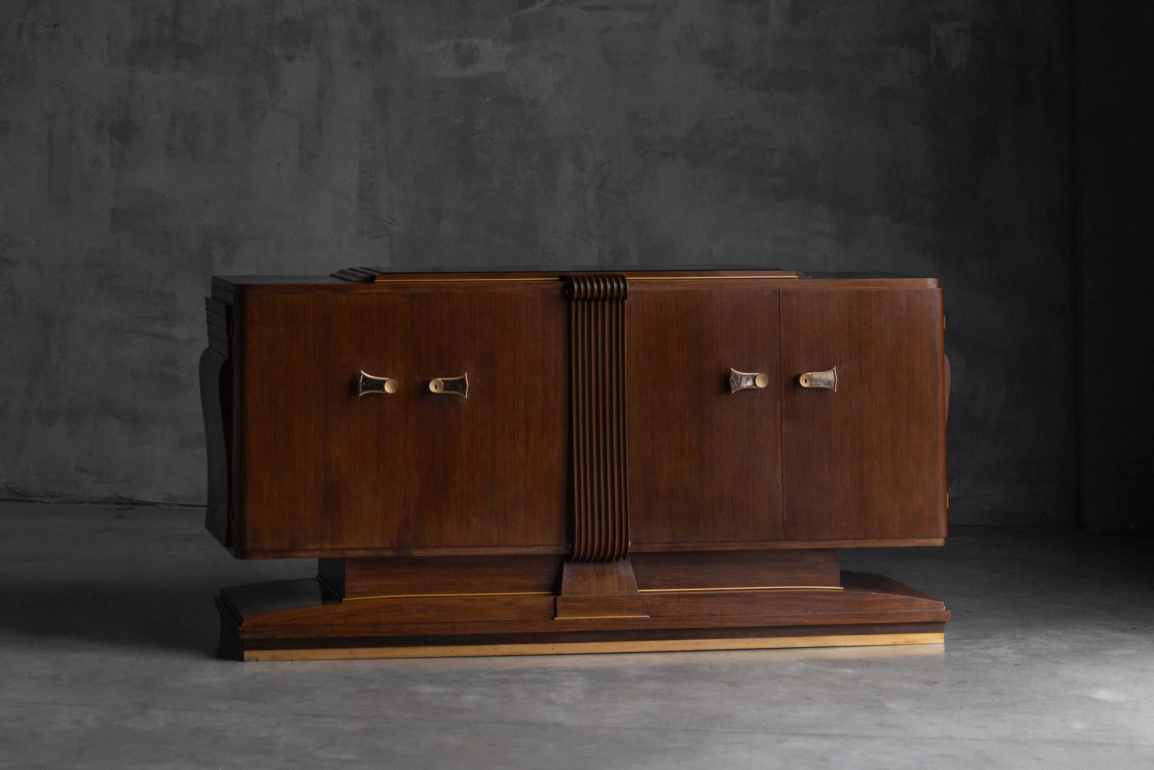 Art Deco walnut sideboard with brass details and sculptural base, France, 1930s