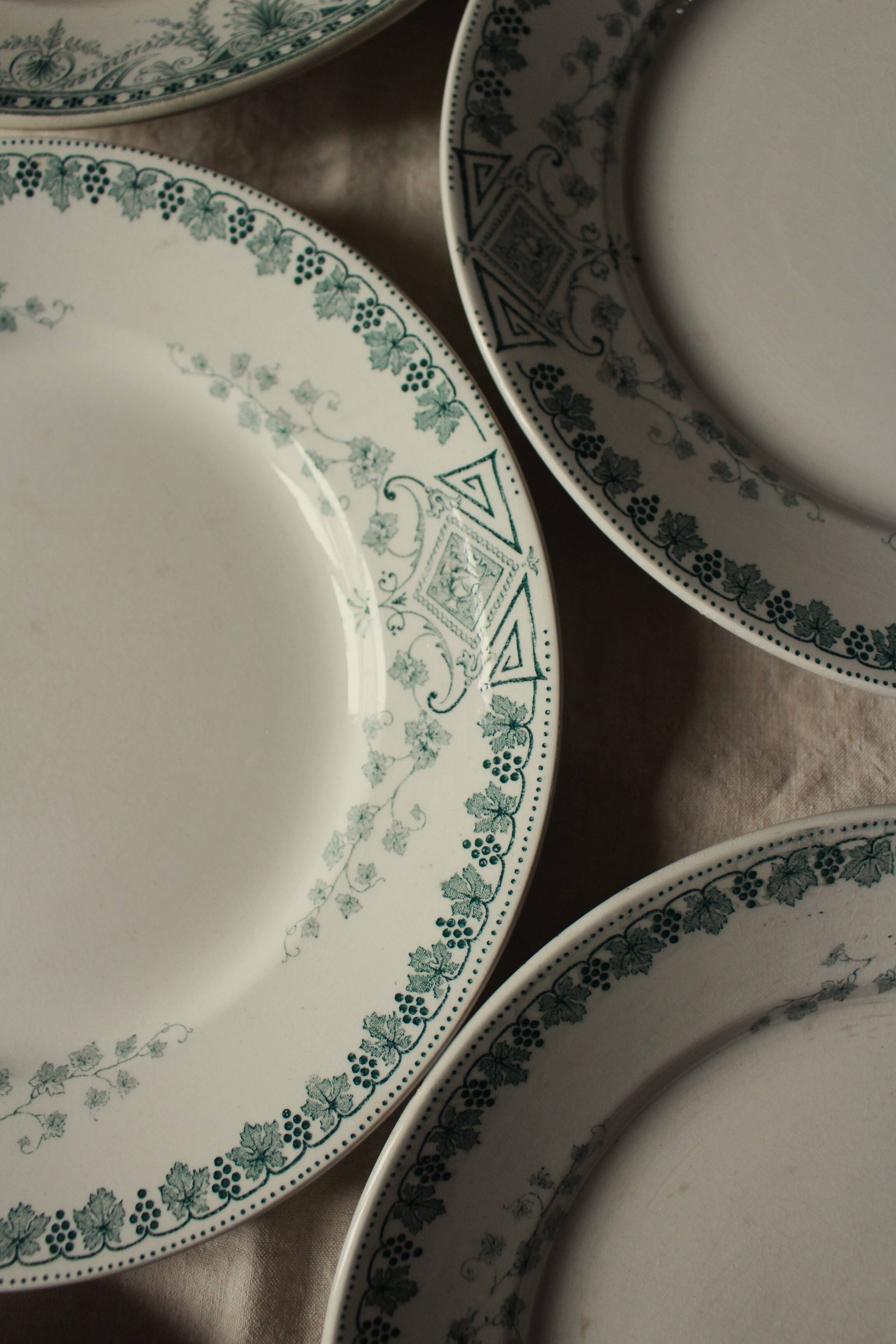 A set of 5 mismatched green blue Terre de fer flat plates
