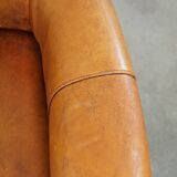 Comfortable, cozy armchair made of sheepskin leather with a proper finish with decorative nailheads