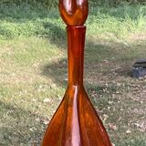 Orange bubbled glass bottle with curved body, circa 1970