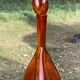 Bouteille en verre bullé orange  à panse incurvée, vers 1970