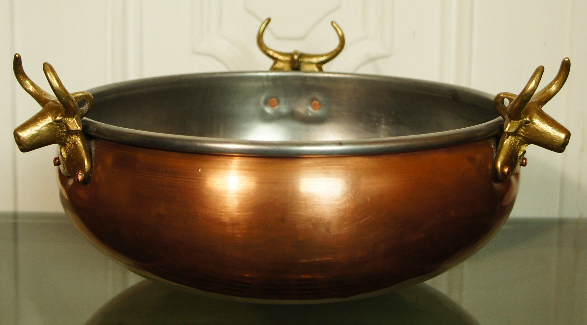 Copper cauldron with golden bronze bull heads