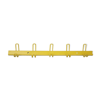 Yellow metal wall coat holder