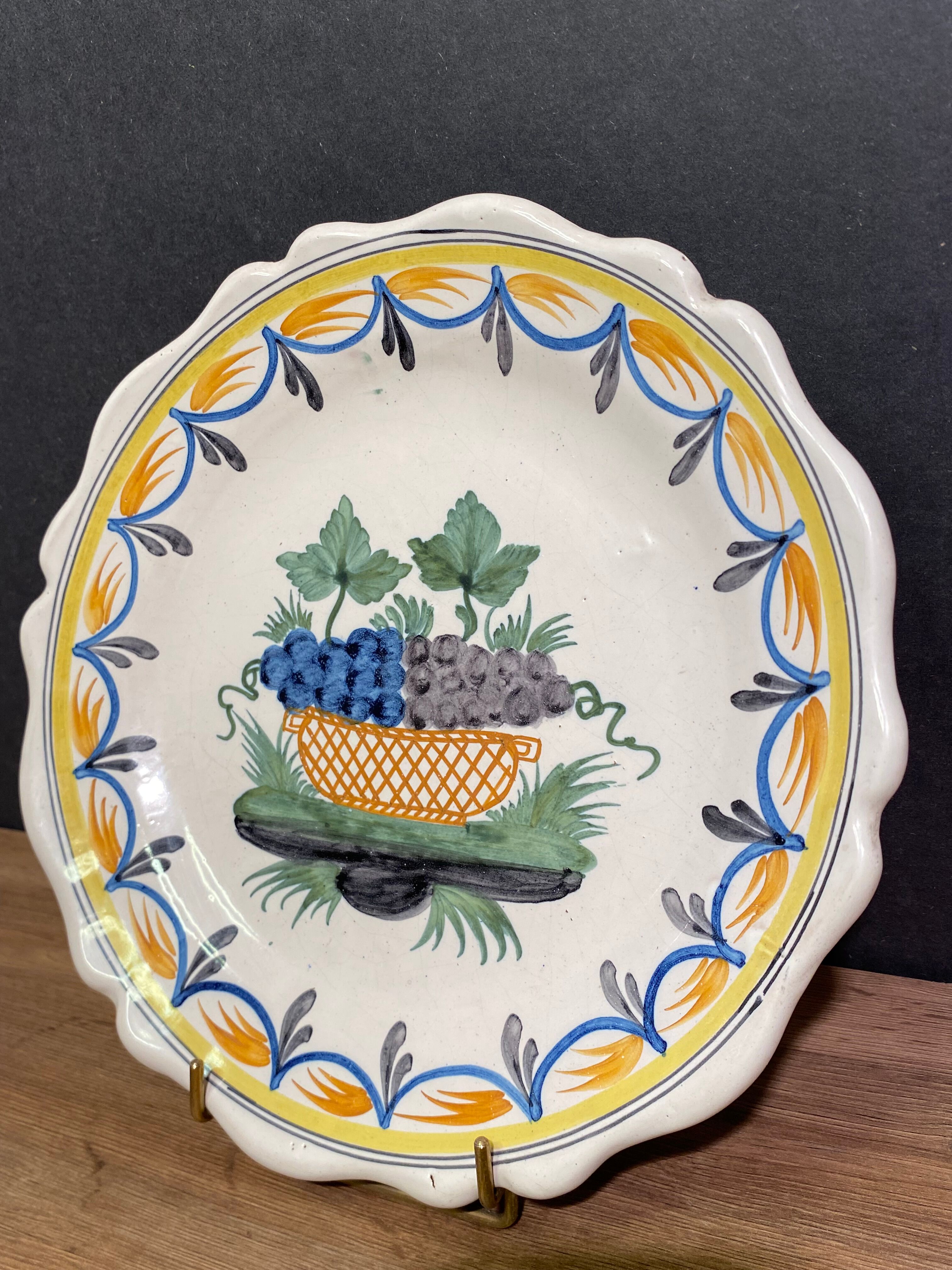 Faience dish of eighteenth-century style nevers decorated with basket with bunches of grapes