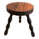 Three-legged stool with beaded wooden legs