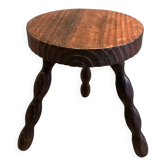 Three-legged stool with beaded wooden legs