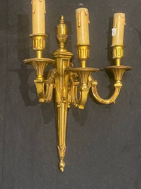 Pair of gilt bronze wall sconces with three lights in the Louis XVI style.