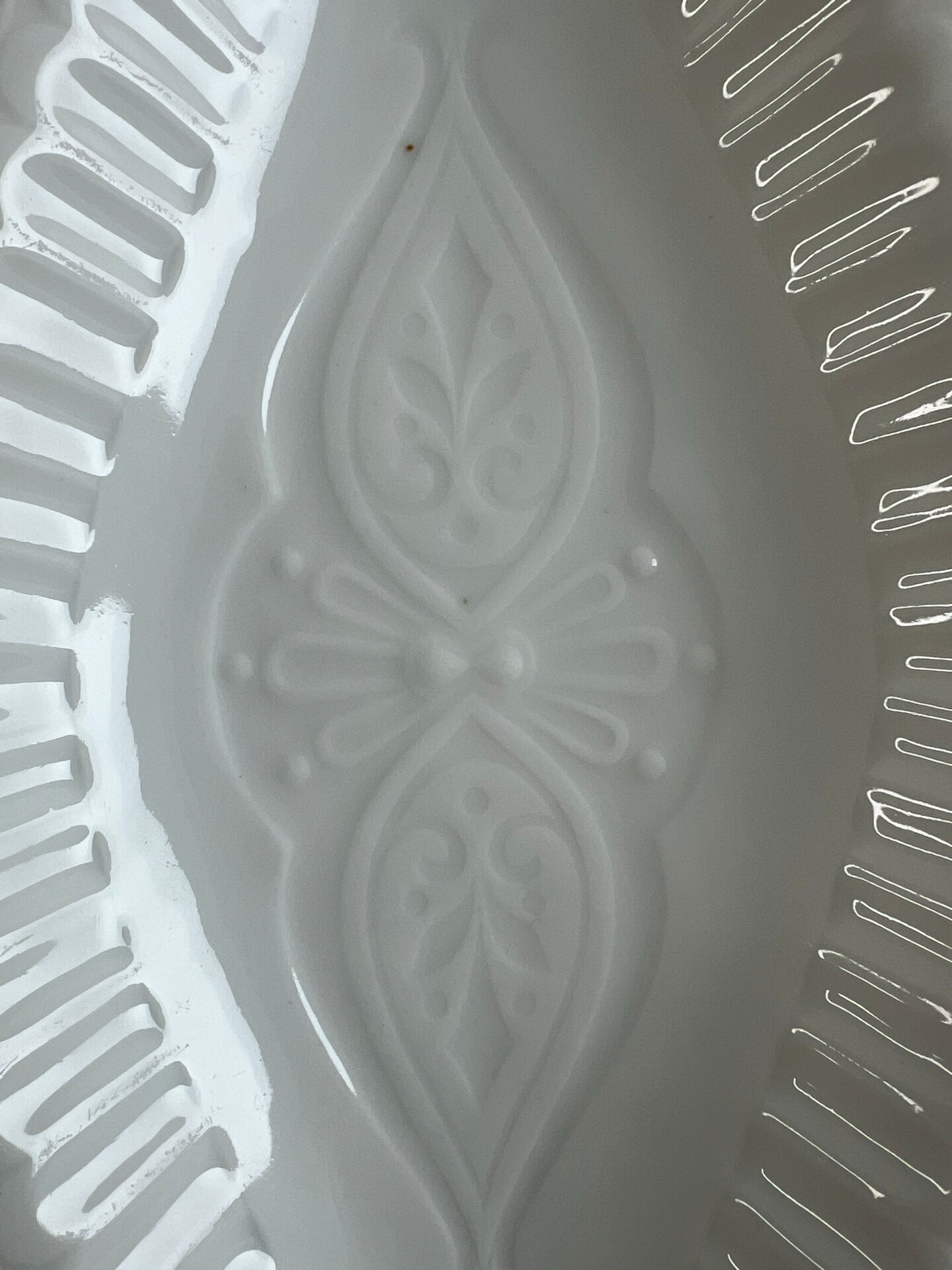 Oval white porcelain ramekin — raised floral pattern