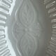Oval white porcelain ramekin — raised floral pattern
