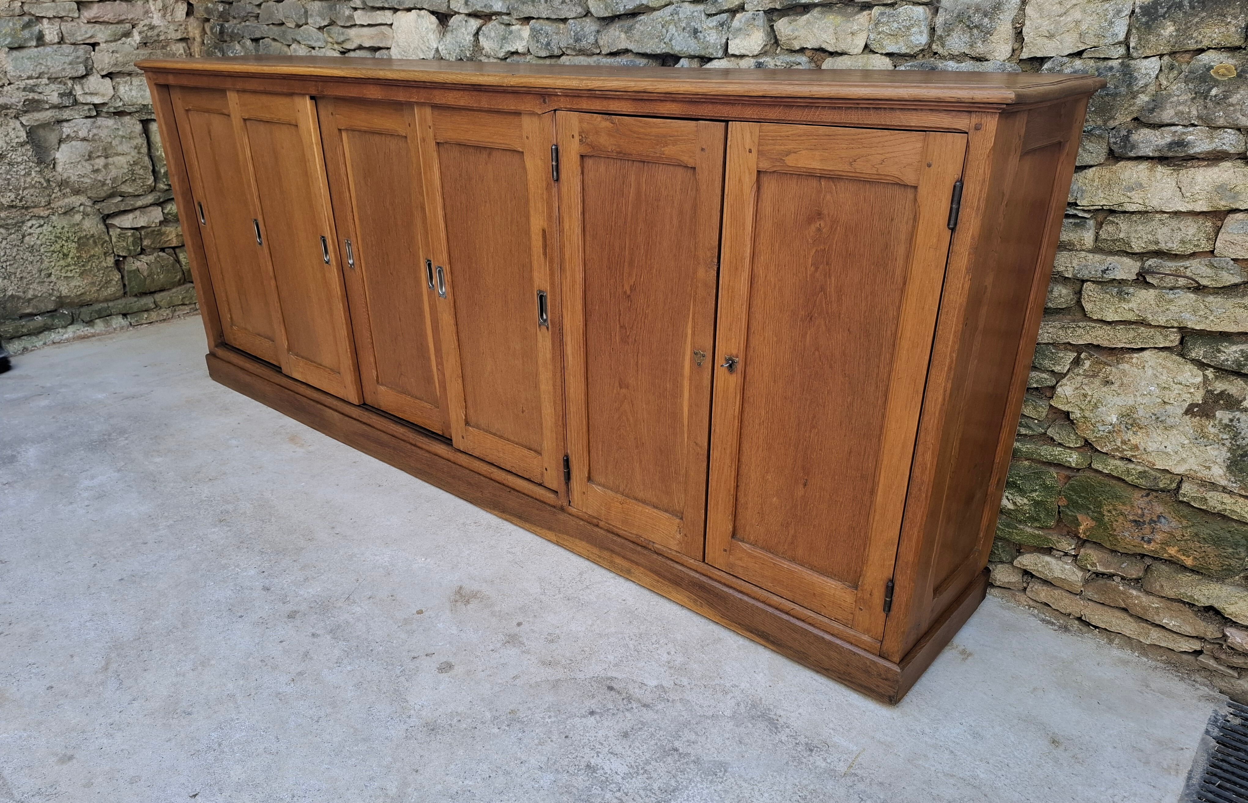 Oak workshop furniture with sliding doors.