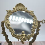 Adjustable psyche mirror of 33 centimeters in gilded bronze with angel ornament