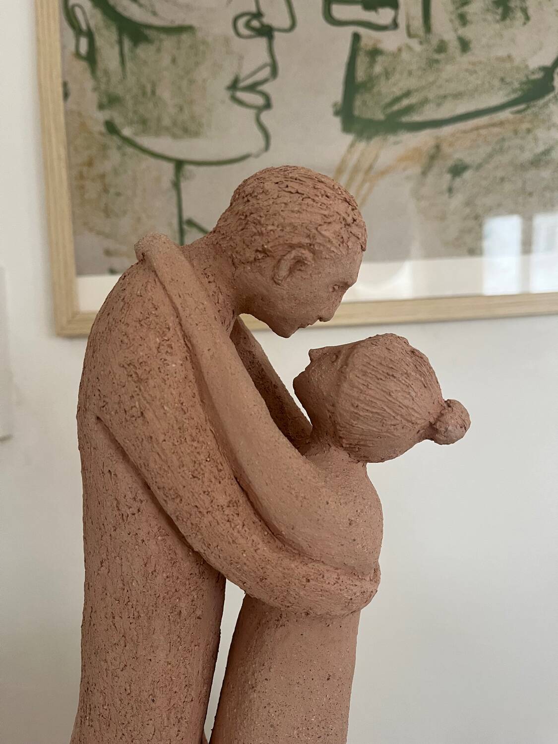 Sculpture of a couple entwined in grog clay.