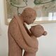 Sculpture of a couple entwined in grog clay.