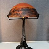 Contemporary mushroom lamp, wrought iron base and shaded orange glass shell