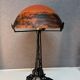 Contemporary mushroom lamp, wrought iron base and shaded orange glass shell