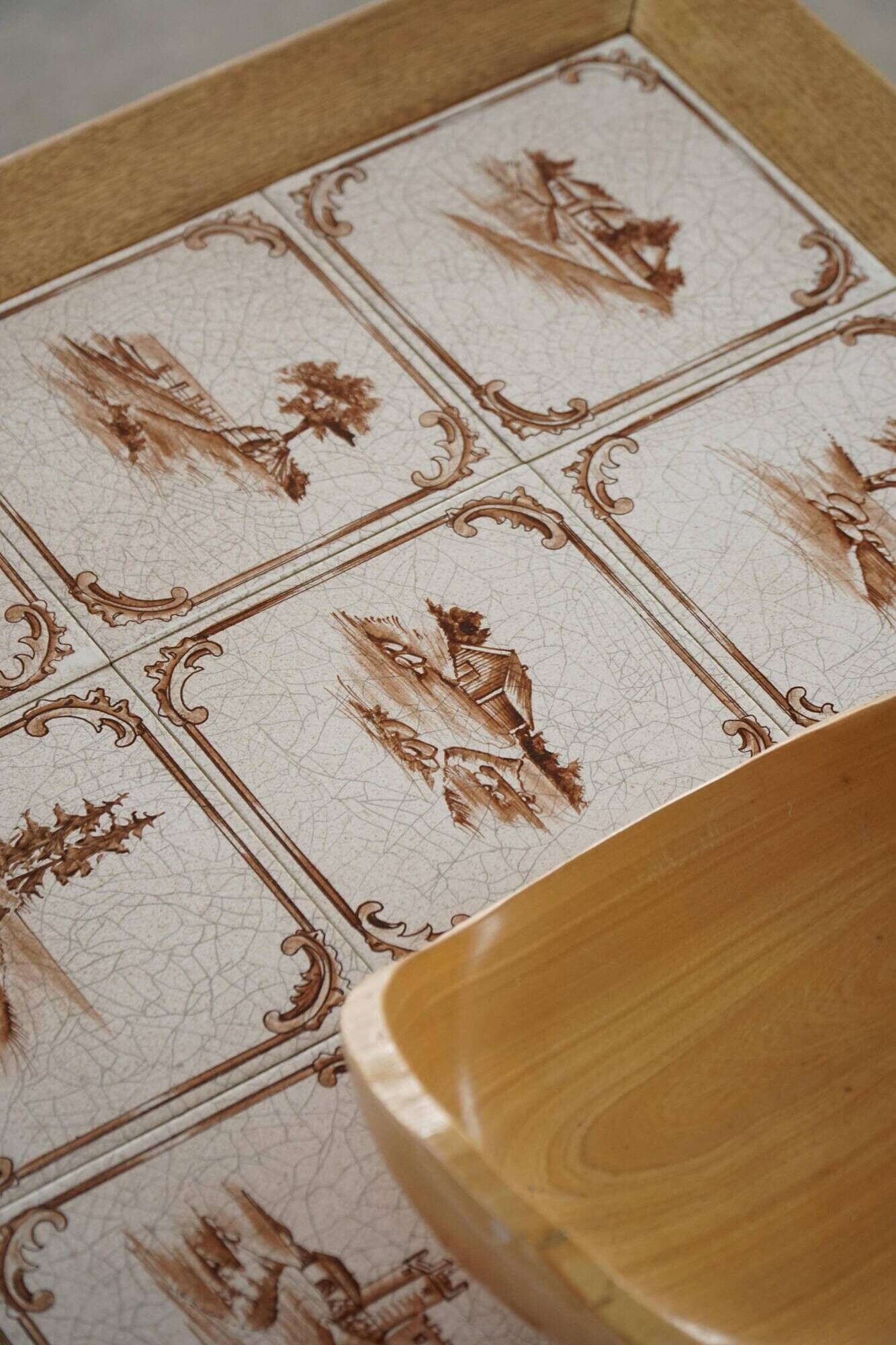 Mid-century modern Danish coffee table in oak with a ceramic top, 1950s.