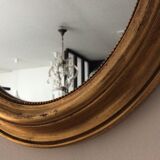 Old oval mirror in gilded wood