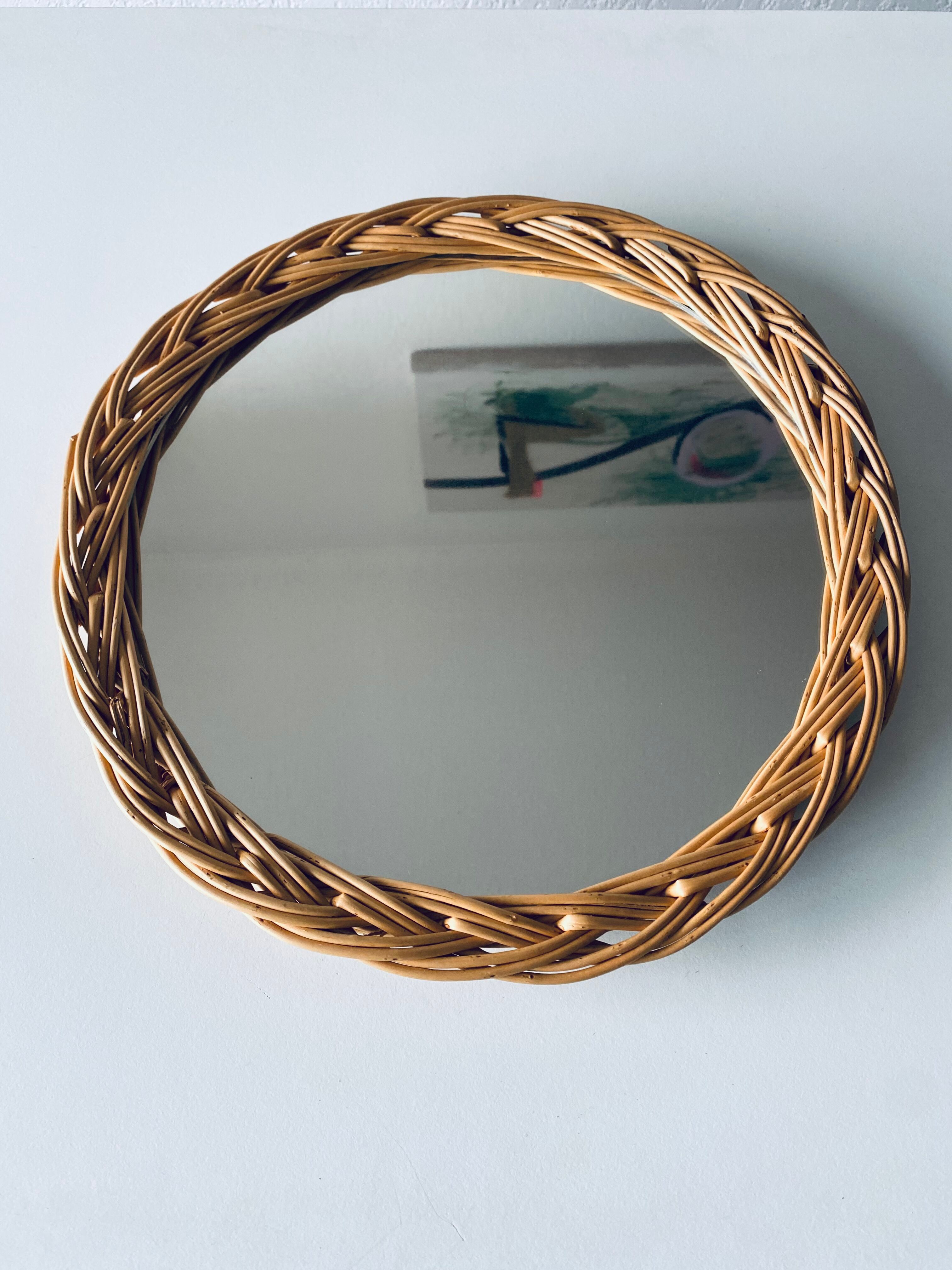 Round mirror in vintage wicker