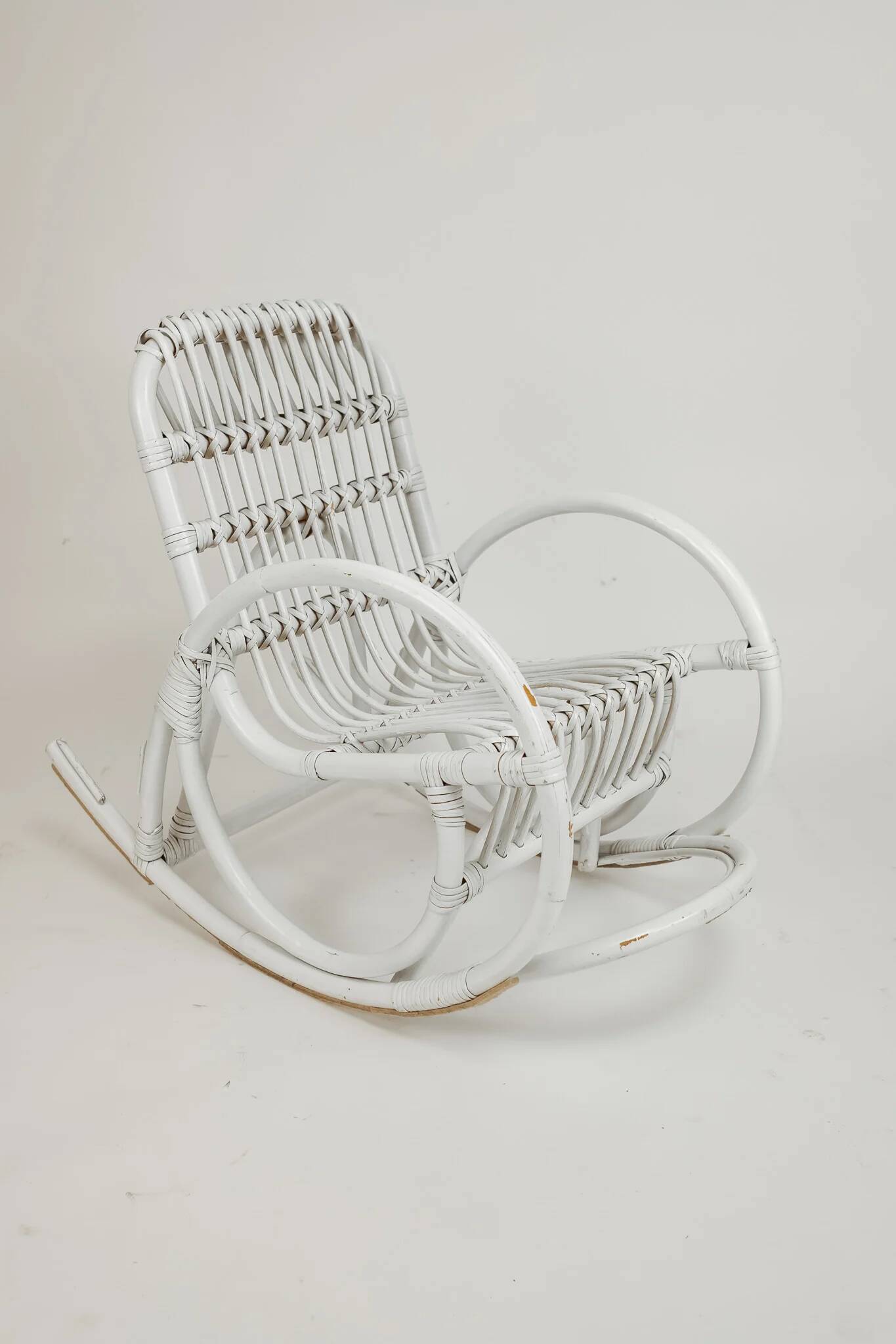 Vintage rocking chair for children in rattan/bamboo.