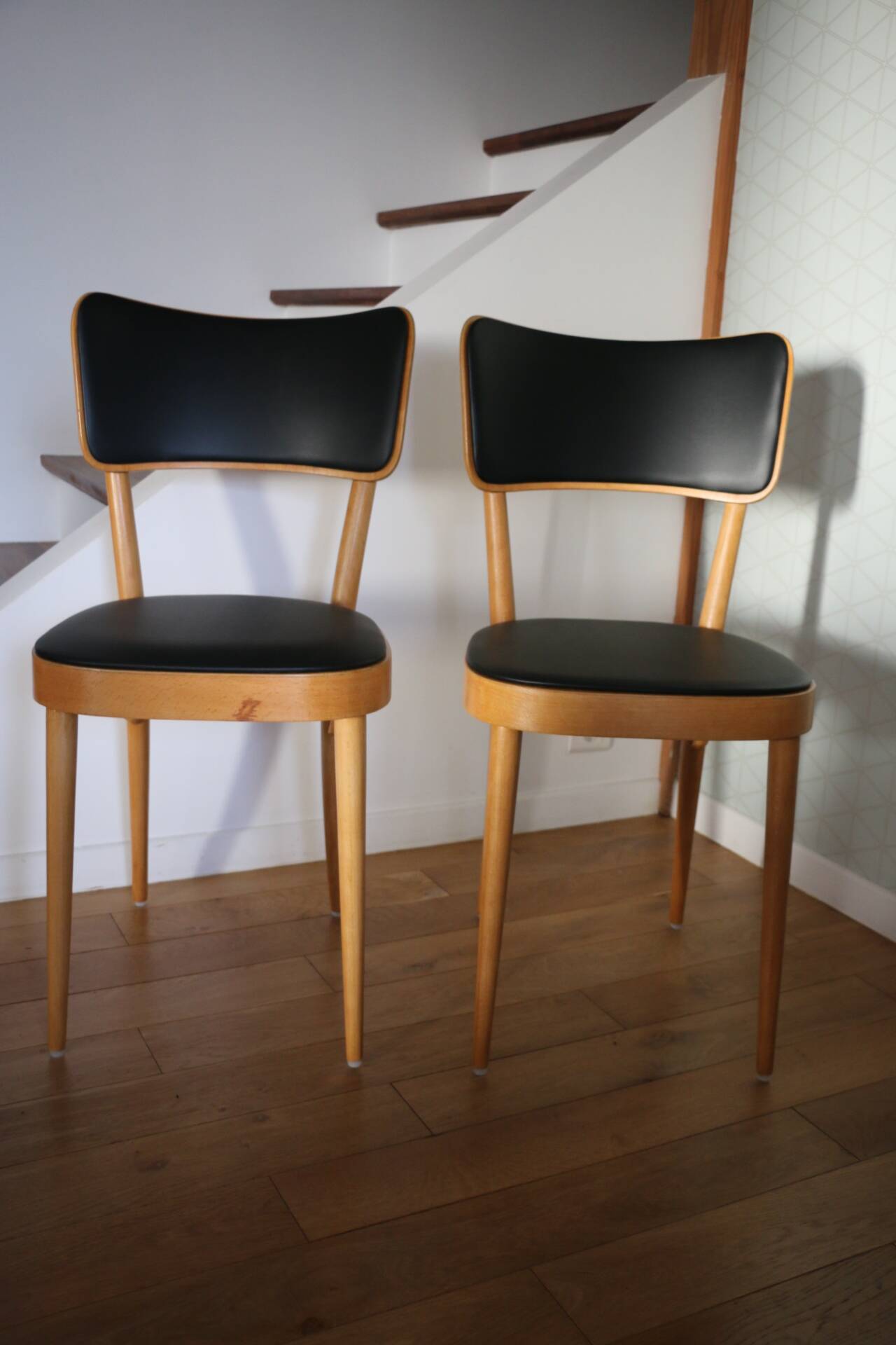 5 baumann chairs with large backs in black faux leather.