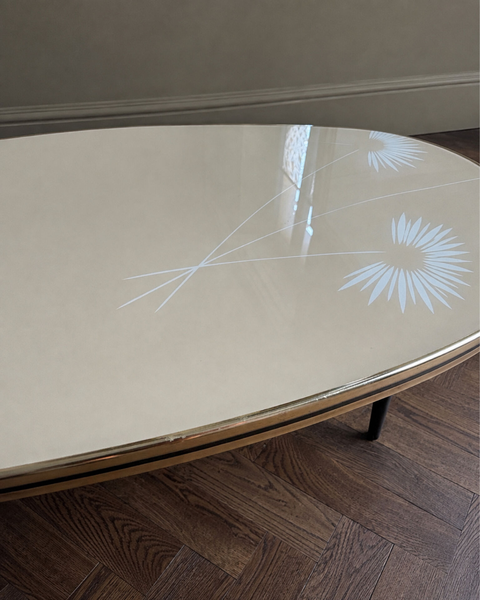 Tripod coffee table with floral design from the 1950s in brass metal and decorative top.