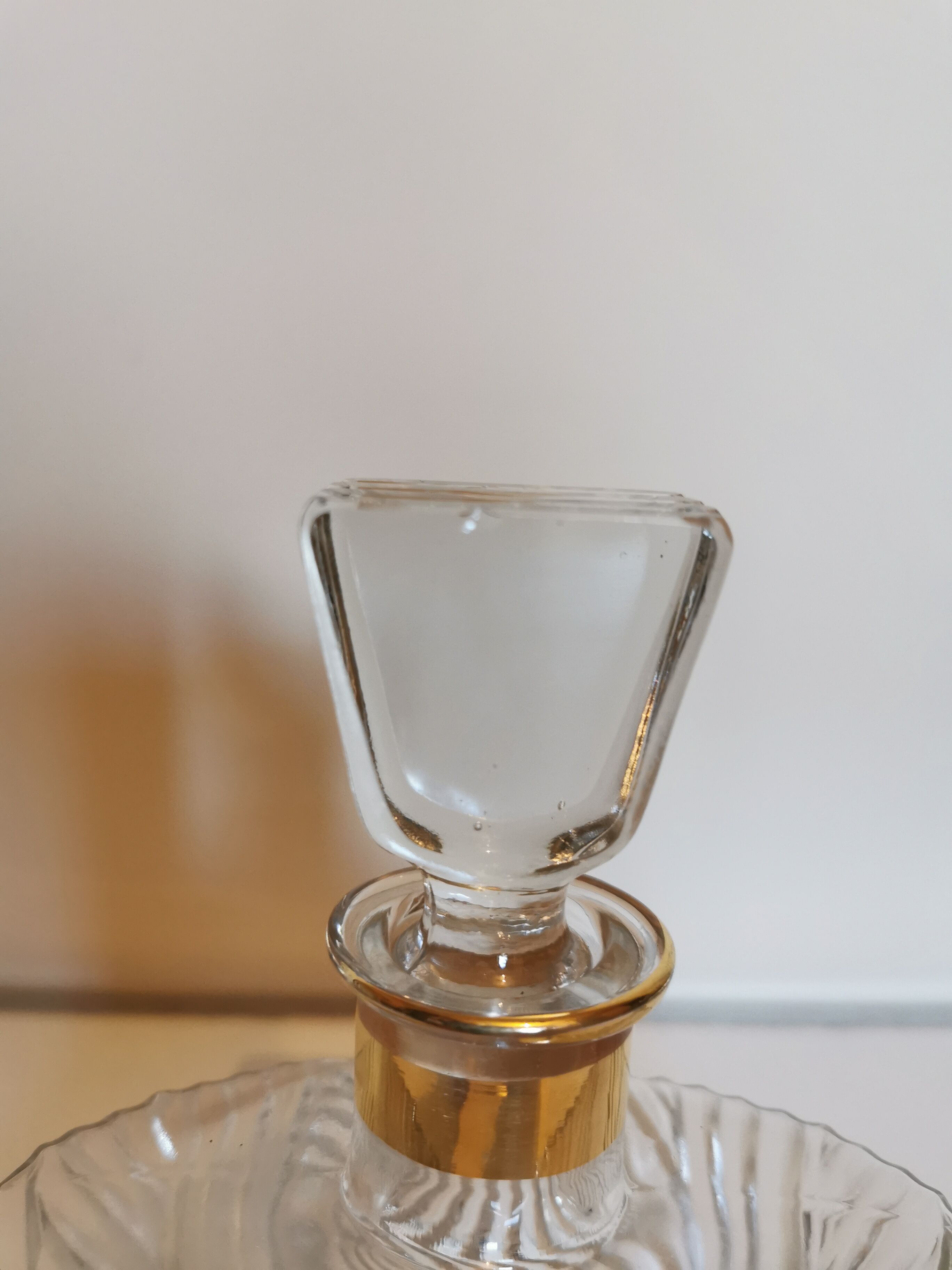 Carved glass decanter, golden band on the collar