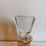 Cut glass carafe with a gold band on the neck.