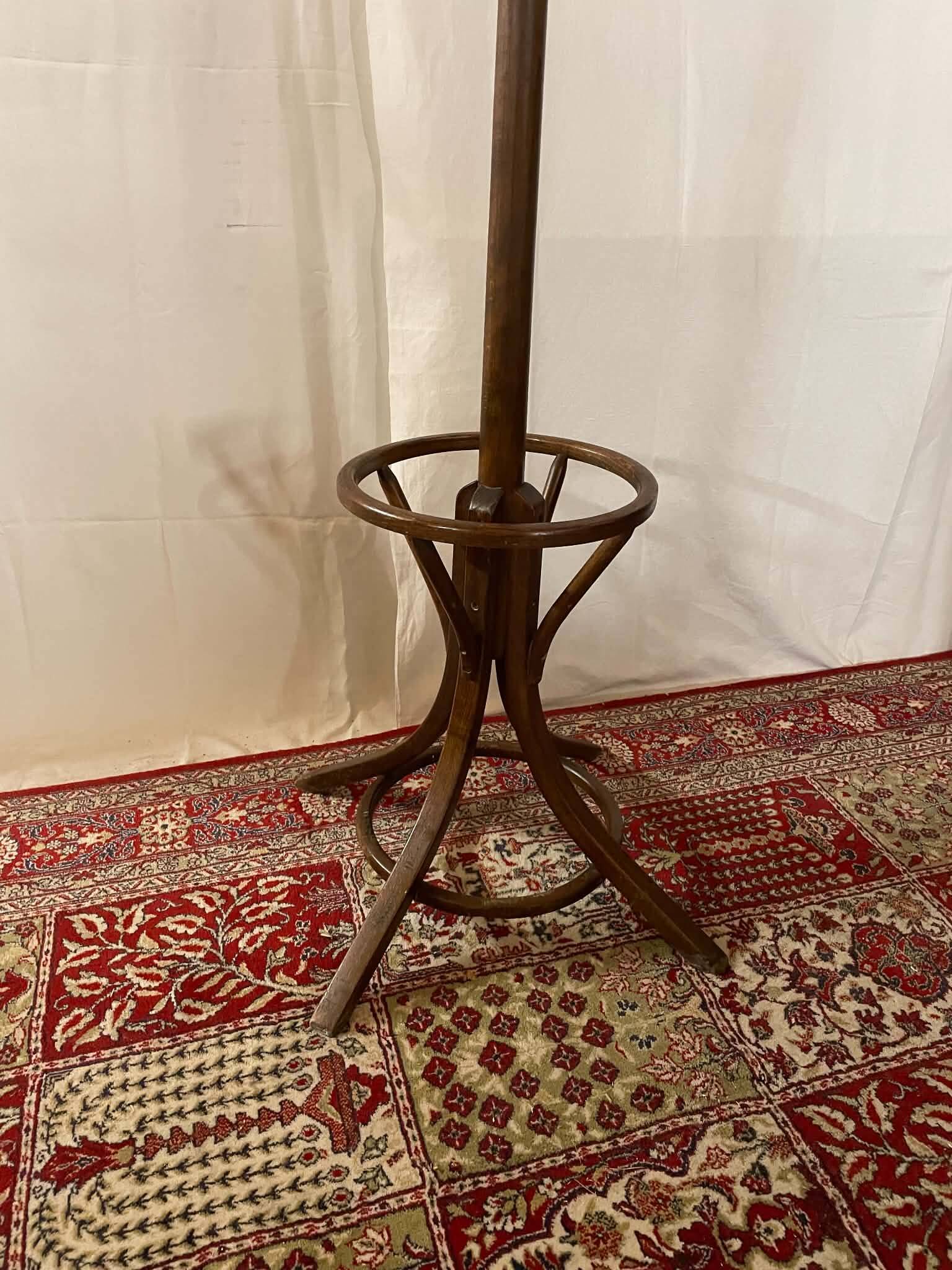 Antique curved wooden coat rack with umbrella stand.