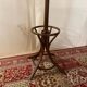 Antique curved wooden coat rack with umbrella stand.