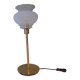 Table lamp with gold metal base and vintage white glass lampshade